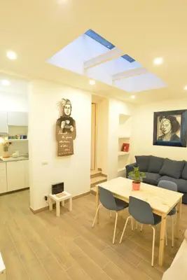 a living room with a table and a couch at Da Cesare e Chloe al Colosseo in Rome