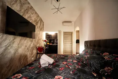 a bedroom with a bed with a pillow on it at farnese jacuzzi apartment in Rome
