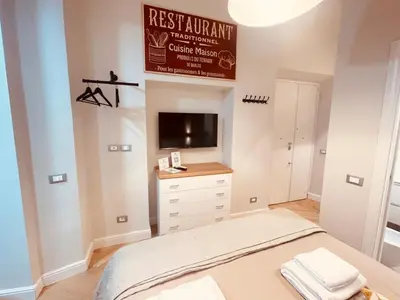a bedroom with a bed and a tv on a wall at THE BREAK - Campo Marzio Studio in Rome
