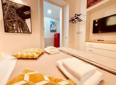 a bedroom with a bed with towels and a tv at THE BREAK - Campo Marzio Studio in Rome