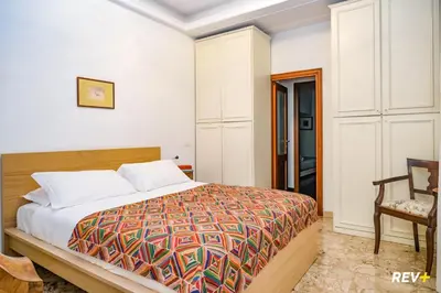 a bedroom with a bed and a chair at Art Apartment Rome City Center in Rome