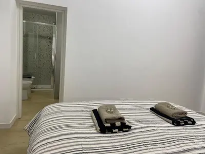 a bedroom with a bed with two towels on it at Condottieri's Hidden Home - Metro C direct to Colosseum in Rome