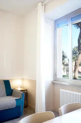 a living room with a couch and a window at Cozy Apartment in the heart of Garbatella in Rome