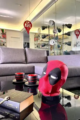a living room with a red costume sitting on a table at Comics Roma Penthouse, Funny Flat Nearby Colosseum in Rome