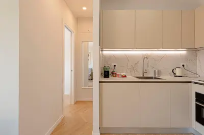 two images of a kitchen with white cabinets at Sangió - Lovely Home in Rome in Rome