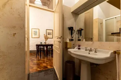 a bathroom with a sink and a table at Navona Sweet Loft in Rome