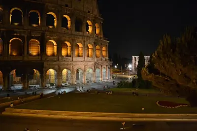 a view of the coliseum at night at Navona Sweet Loft in Rome