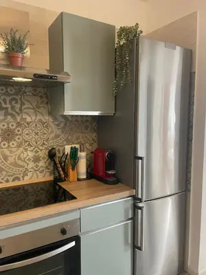 a kitchen with a stainless steel refrigerator at Appartamento 2 bagni, 2 camere a Piramide ostiense in Rome