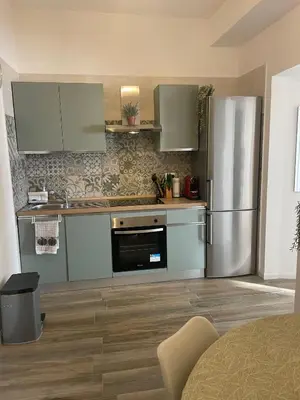 a kitchen with a stainless steel refrigerator at Appartamento 2 bagni, 2 camere a Piramide ostiense in Rome