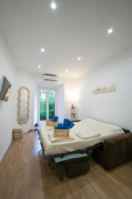 a bedroom with a large bed and a mirror at Camelia's Garden in Rome