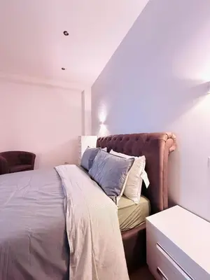 a bedroom with a bed with pillows on it at TRASTEVERE PALACE GUEST House in Rome
