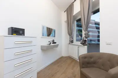 a living room with a chair and a dresser at TRASTEVERE PALACE GUEST House in Rome