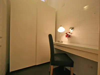 a black chair sitting at a desk with a lamp at Suite Cernaia Holidays in Rome