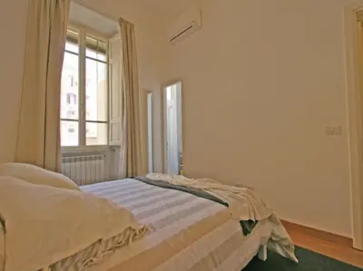 a bedroom with a bed and a window at Suite Cernaia Holidays in Rome