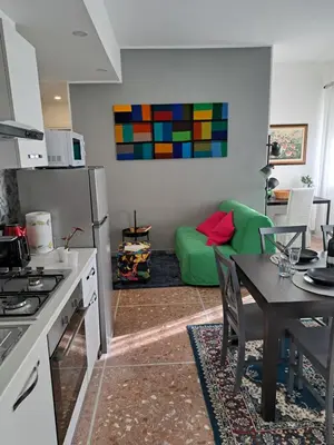 a kitchen and living room with a table and a couch at Appartamento Prenestina 74 in Rome