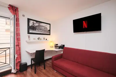 a small bathroom with a toilet and a window at Trastevere luxury apartment in Rome