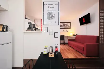 a living room with a red chair and a table at Trastevere luxury apartment in Rome
