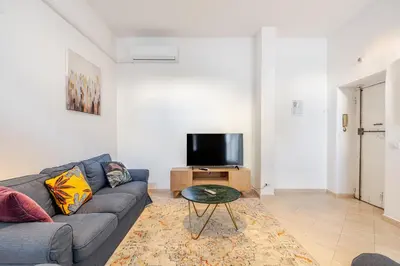 a living room with a couch and a tv at Campo de Fiori - Casa Storica 4bdr con Terrazza in Rome