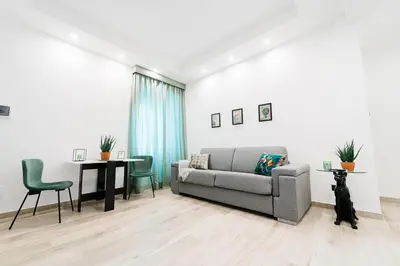 a living room with a couch and a table at Maison Salvia in Rome