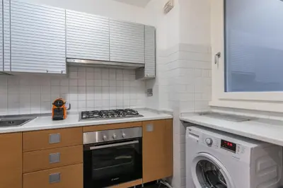 a kitchen with a stove and a washing machine at Casa degli Dei in Rome