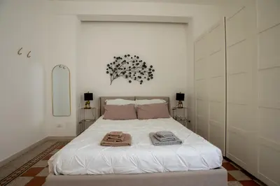 a bedroom with a bed with towels on it at UrbanPiramide - Roma in Rome