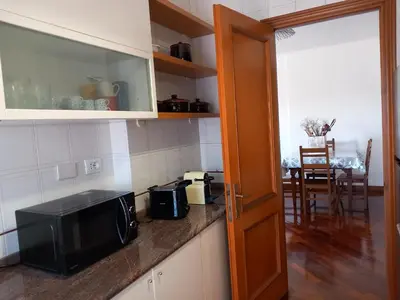 a kitchen with a microwave and a kitchen with a table at St Peter's view penthouse 300 mt metro A stop in Rome