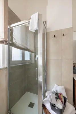 a shower with a glass door in a bathroom at Gianicolo Trastevere Exclusive Apartments in Rome