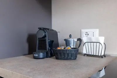 a counter with a basket of fruit on a counter top at Gianicolo Trastevere Exclusive Apartments in Rome