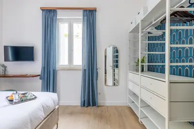 a bedroom with a bed and a staircase at Gianicolo Trastevere Exclusive Apartments in Rome