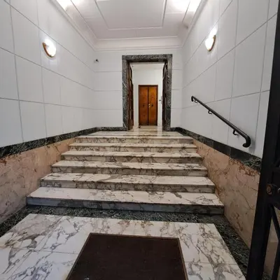 a corridor of a building with stairs and a door at Giovanni Home Porta Metronia in Rome
