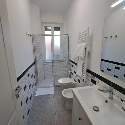 a bathroom with a shower and a toilet and a sink at Giovanni Home Porta Metronia in Rome