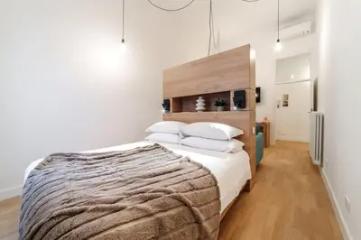 a bedroom with a large bed with white sheets and pillows at Casa Trilussa Luxury House with Terrace in Trastevere in Rome