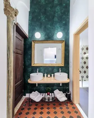 a bathroom with two sinks and a mirror at Casa Trilussa Luxury House with Terrace in Trastevere in Rome