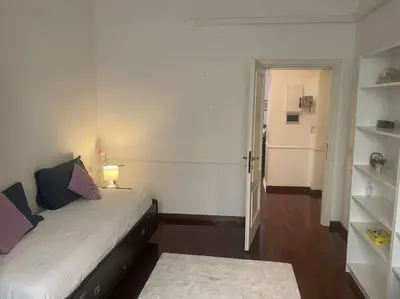 a bedroom with a bed and a door to a hallway at Via Veneto e La Dolce Vita in Rome