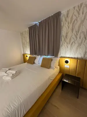 a bedroom with a large white bed with a window at NeW!The Place Vaticano 278 guest house in Rome