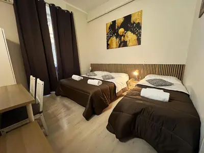 a room with two beds in a room at Stephany's Guesthouse in Rome