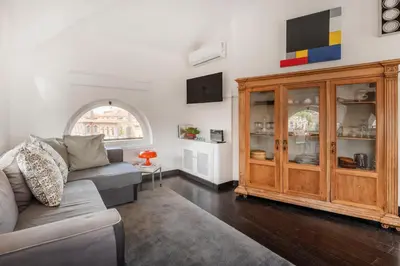 a living room with a couch and a wooden cabinet at Andreoli 2 apartment Rooftop in Rome