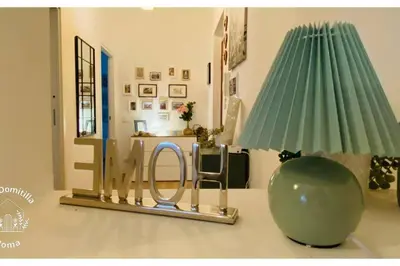 a mirror on a table with a chair and a lamp at Casa Domitilla in Rome