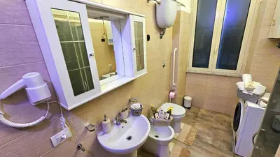 a bathroom with a sink and a toilet at A Casa Simpatia Vaticano in Rome