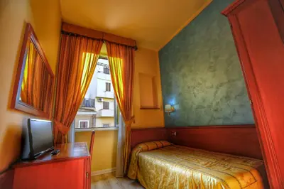a small bedroom with a bed and a window at Hotel Giolitti in Rome