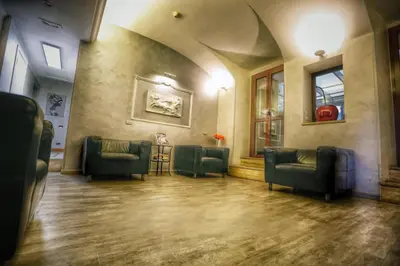 a waiting room with couches and chairs in a building at Hotel Giolitti in Rome