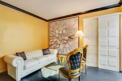 a living room with a white couch and a table at Spanish Steps Boutique Gold Apartment in Rome