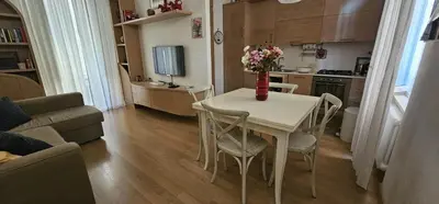 a kitchen with a table with a vase of flowers on it at Casa Capponi - A San Pietro in Rome
