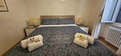 a bedroom with a large bed with two chairs at Casa Capponi - A San Pietro in Rome