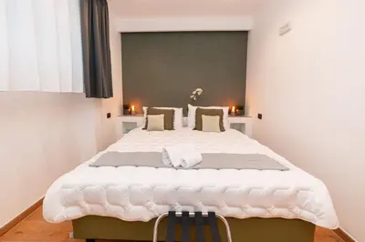 a bedroom with a large white bed in a room at Il Melograno - Casa Palmeri in Rome