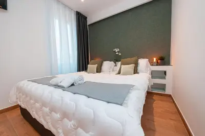 a bedroom with a large white bed in a room at Il Mandorlo - Casa Palmeri in Rome