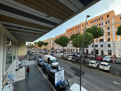 a city street with cars parked in a parking lot at San Giovanni's Cozy Apartment in Rome