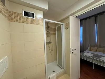 a bathroom with a walk in shower and a shower at San Giovanni's Cozy Apartment in Rome