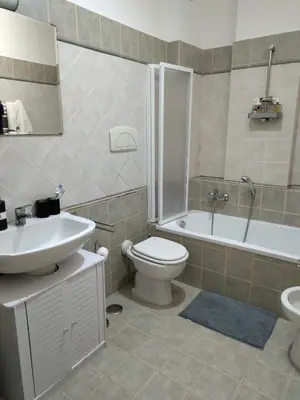 a bathroom with a sink and a toilet and a tub at La Casa Vicino a Tutto in Rome