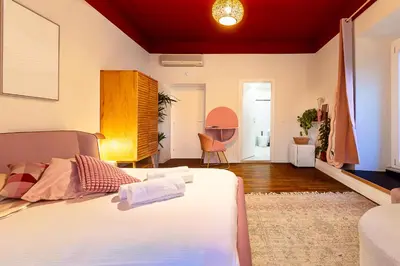 a bedroom with a bed and a window at DomusFebo SanGiovanniSuites in Rome